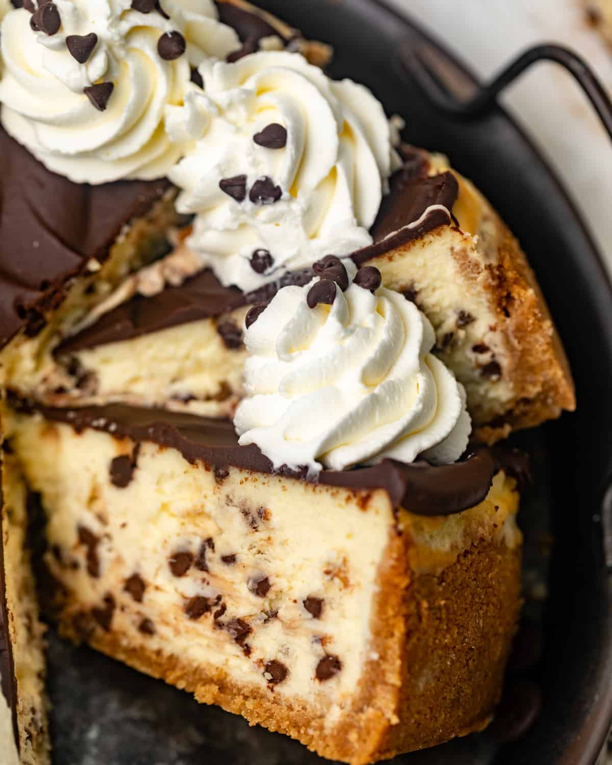 slices of a chocolate chip cheesecake on a serving tray.