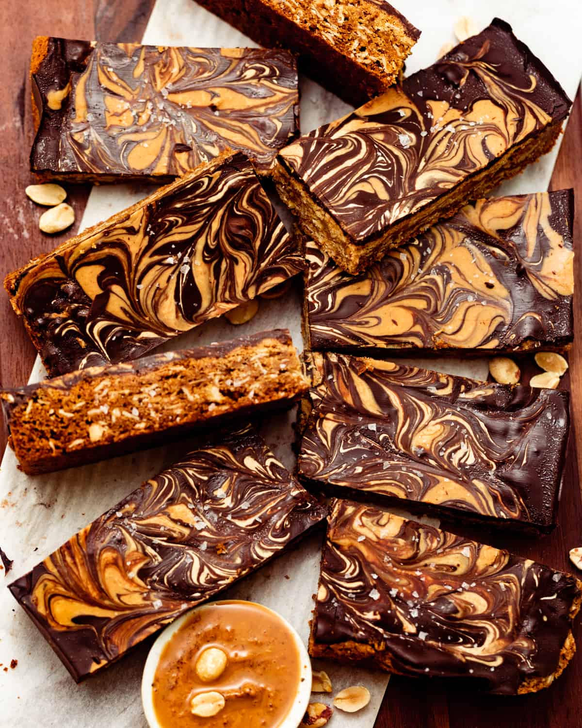 chocolate peanut butter oatmeal bars on a brown plate cut into squares.