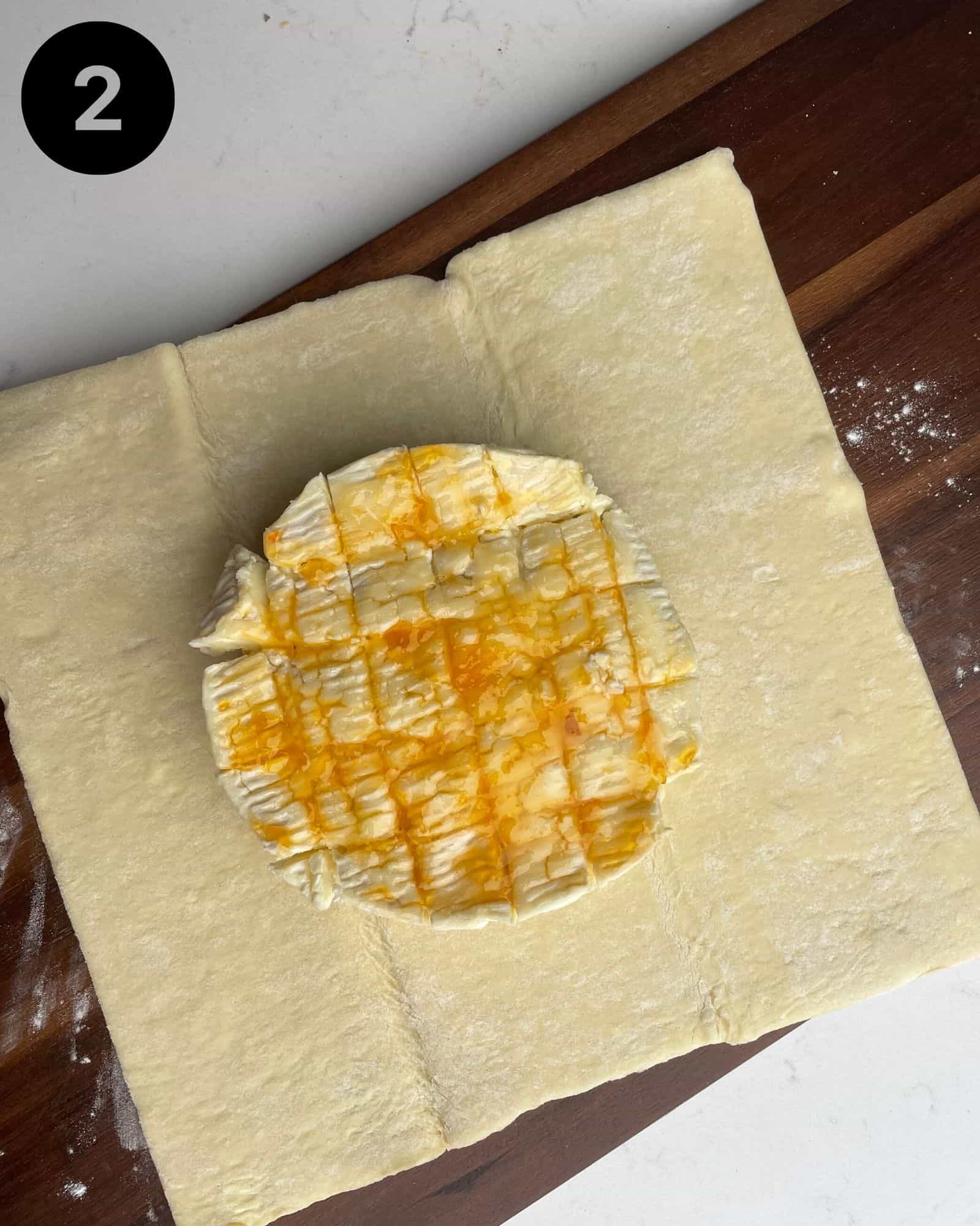 a wheel of brie on top of a piece of puff pastry.