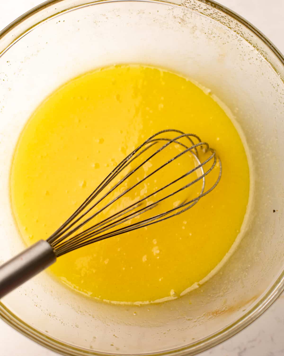 butter and sugar whisked together in a bowl.