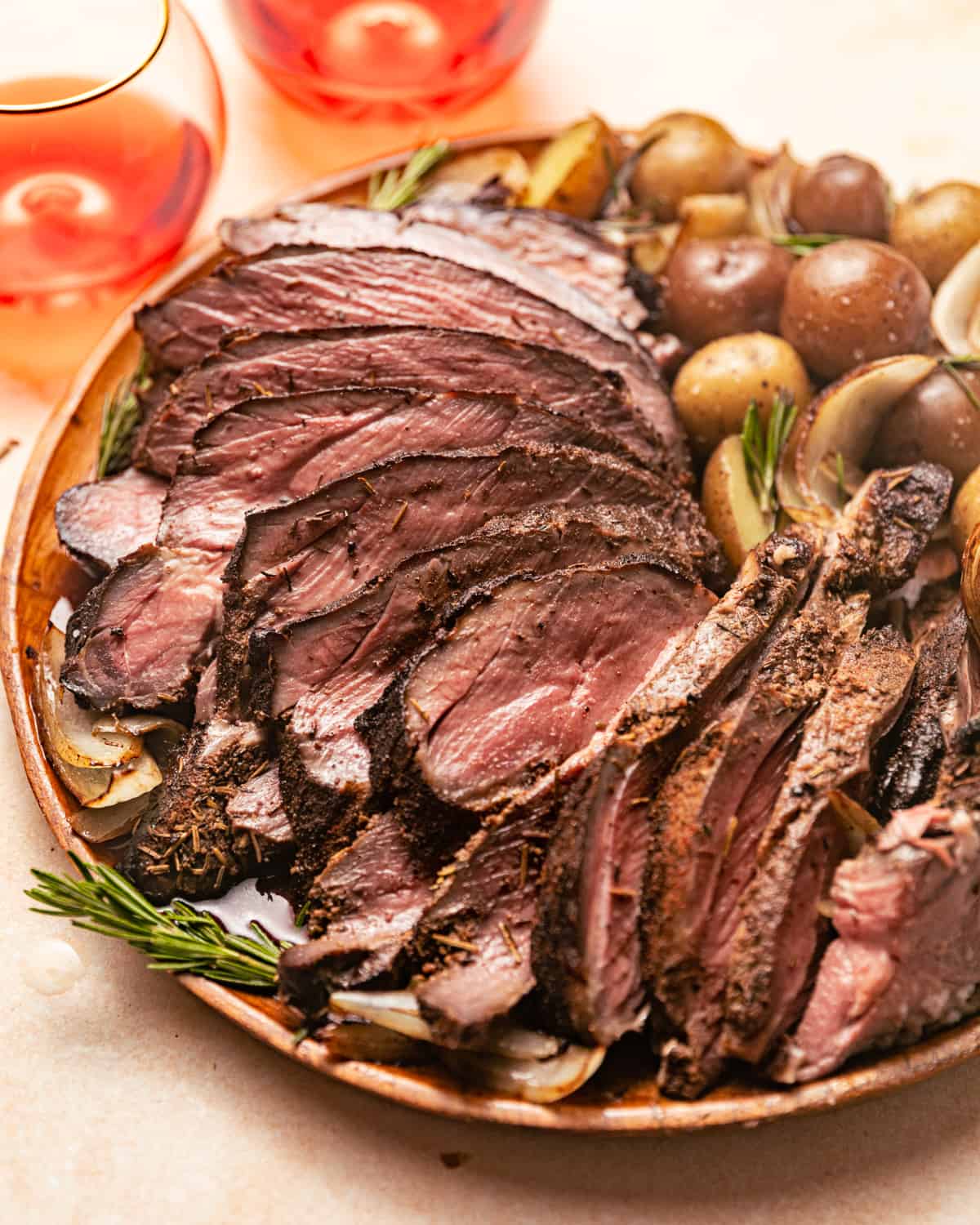 carved smoked leg of lamb garnished with rosemary.