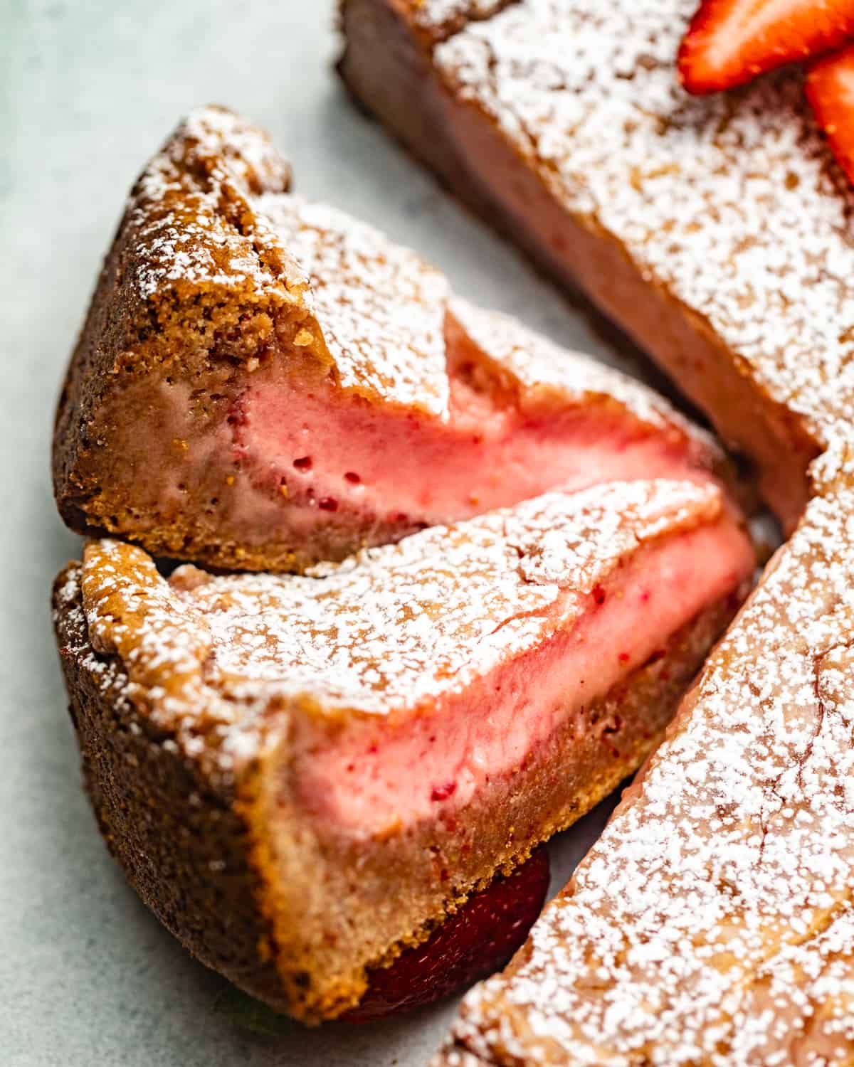 strawberry cake slices cut and placed on their side.