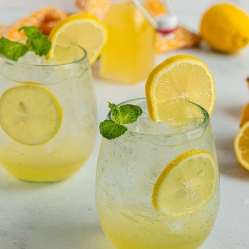 lemon soda in a glass with lemon slices.