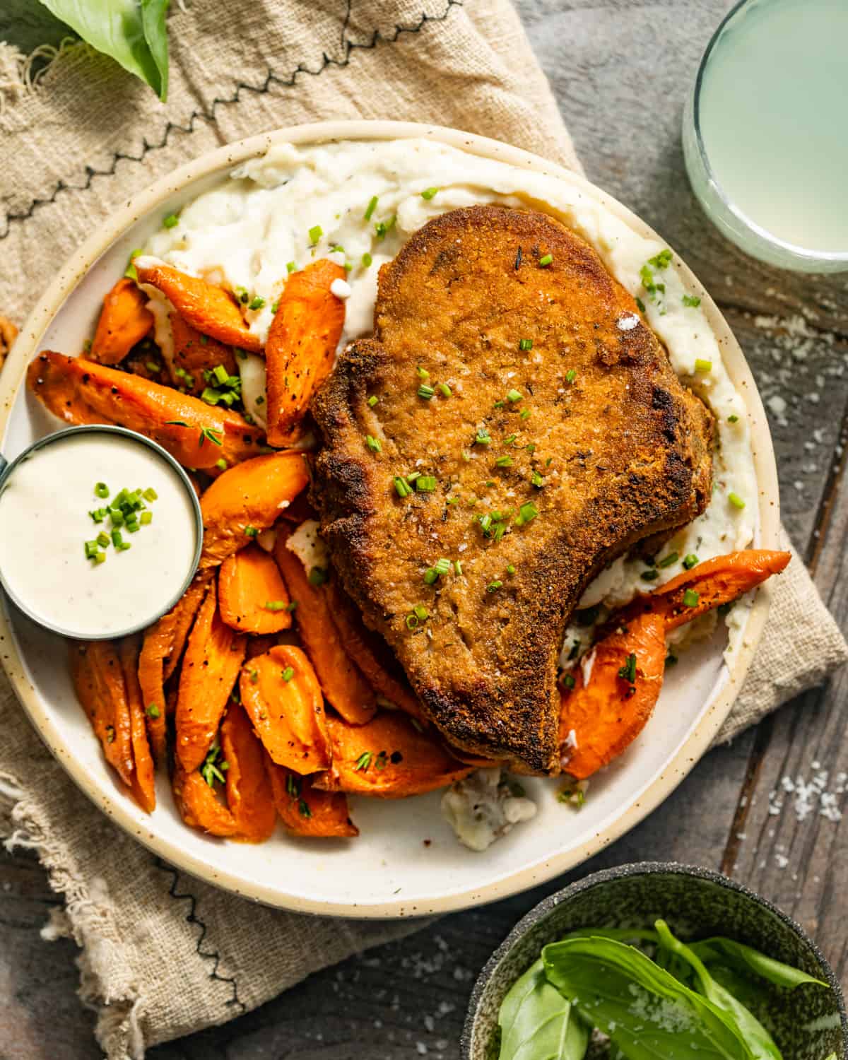shake and bake pork chops on a plate with mashed potatoes and carrots.