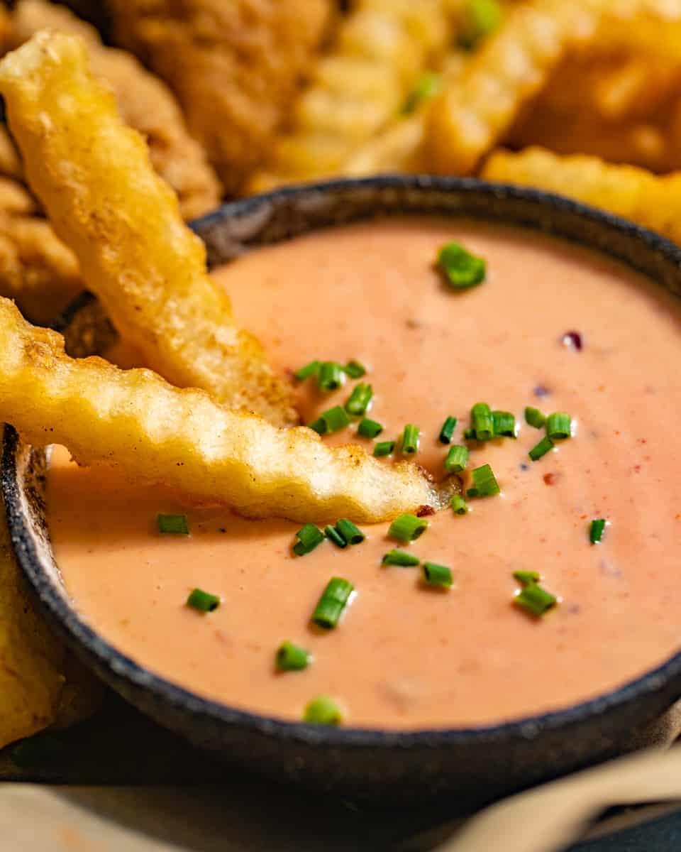 french fries dipped in boom boom sauce.