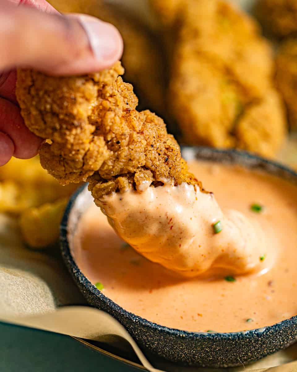 a chicken tender dipped in boom boom sauce.