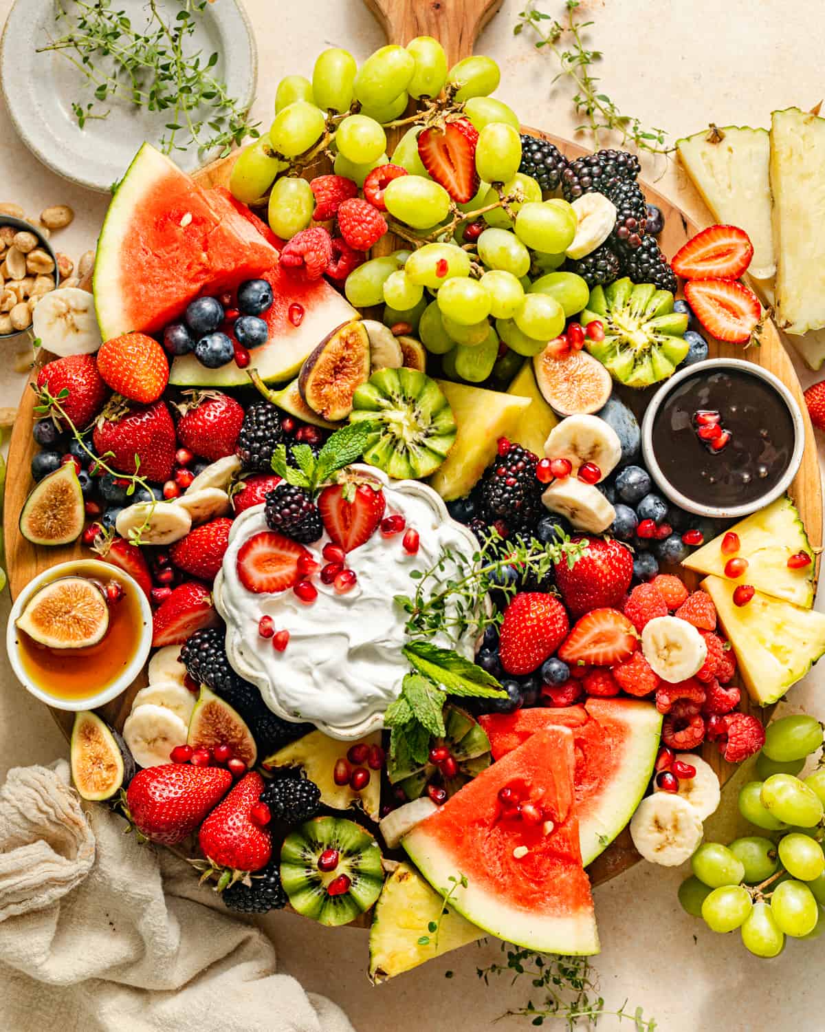 fruit arranged on a fruit platter with dips.