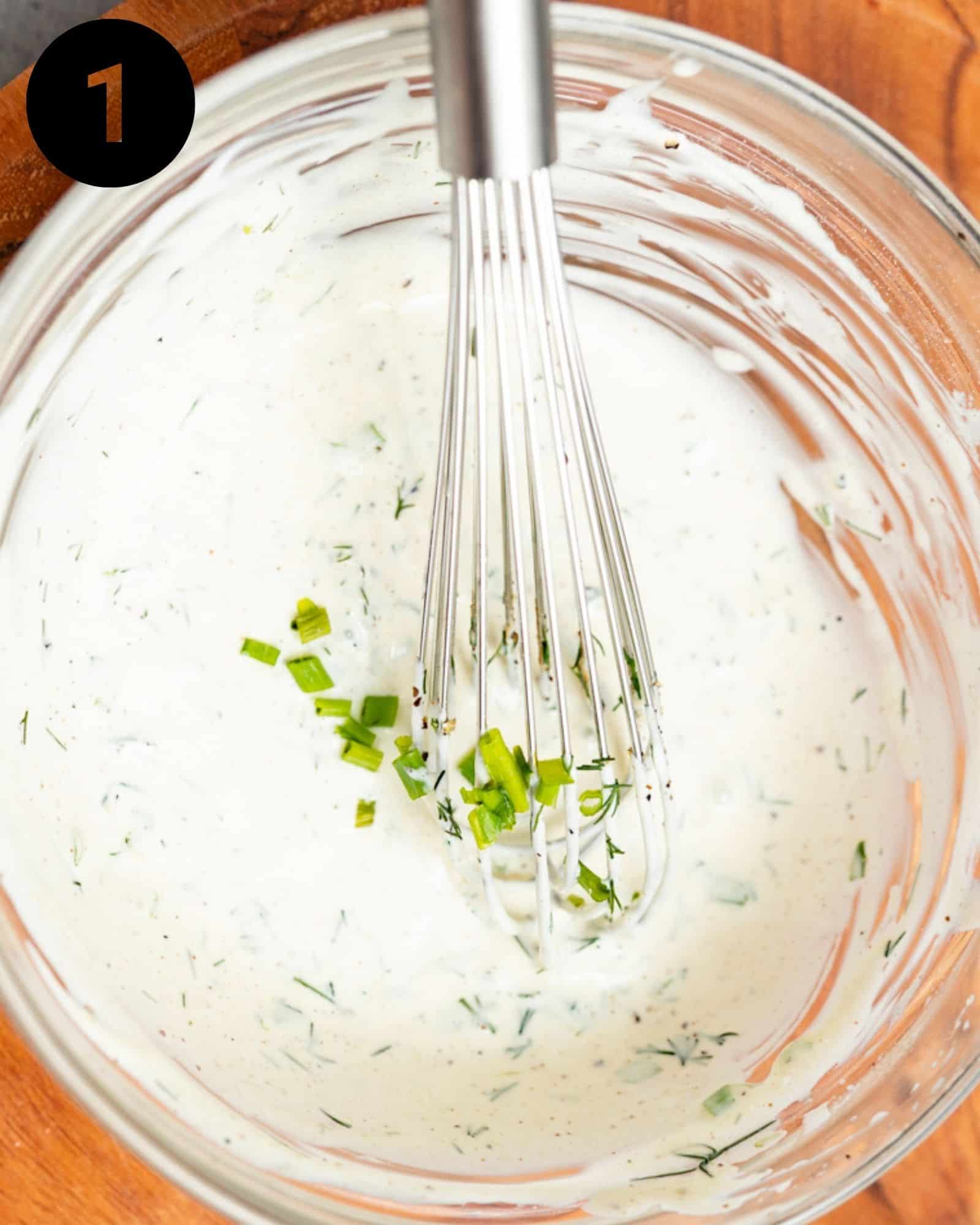 mayo, lemon juice, dill, chives, and seasonings whisked together in a bowl.