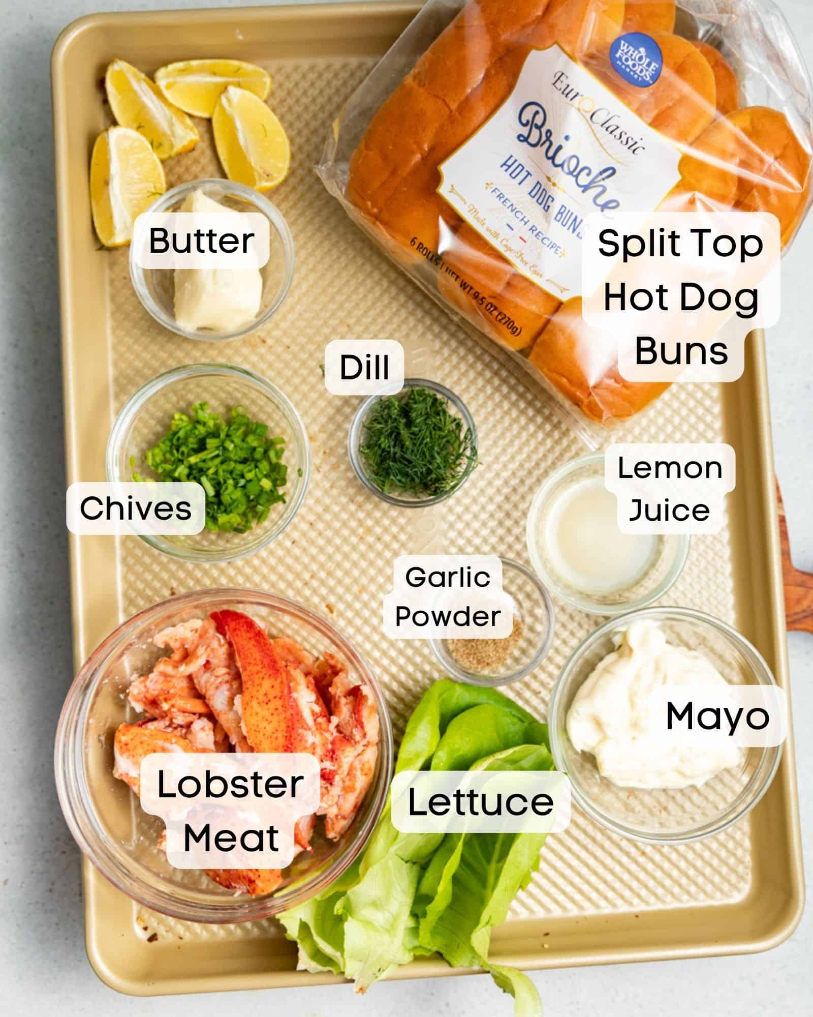 ingredients to make lobster rolls - lobster mat, hot dog buns, lettuce, mayo, lemon juice, seasonings, butter, chives, and dill.