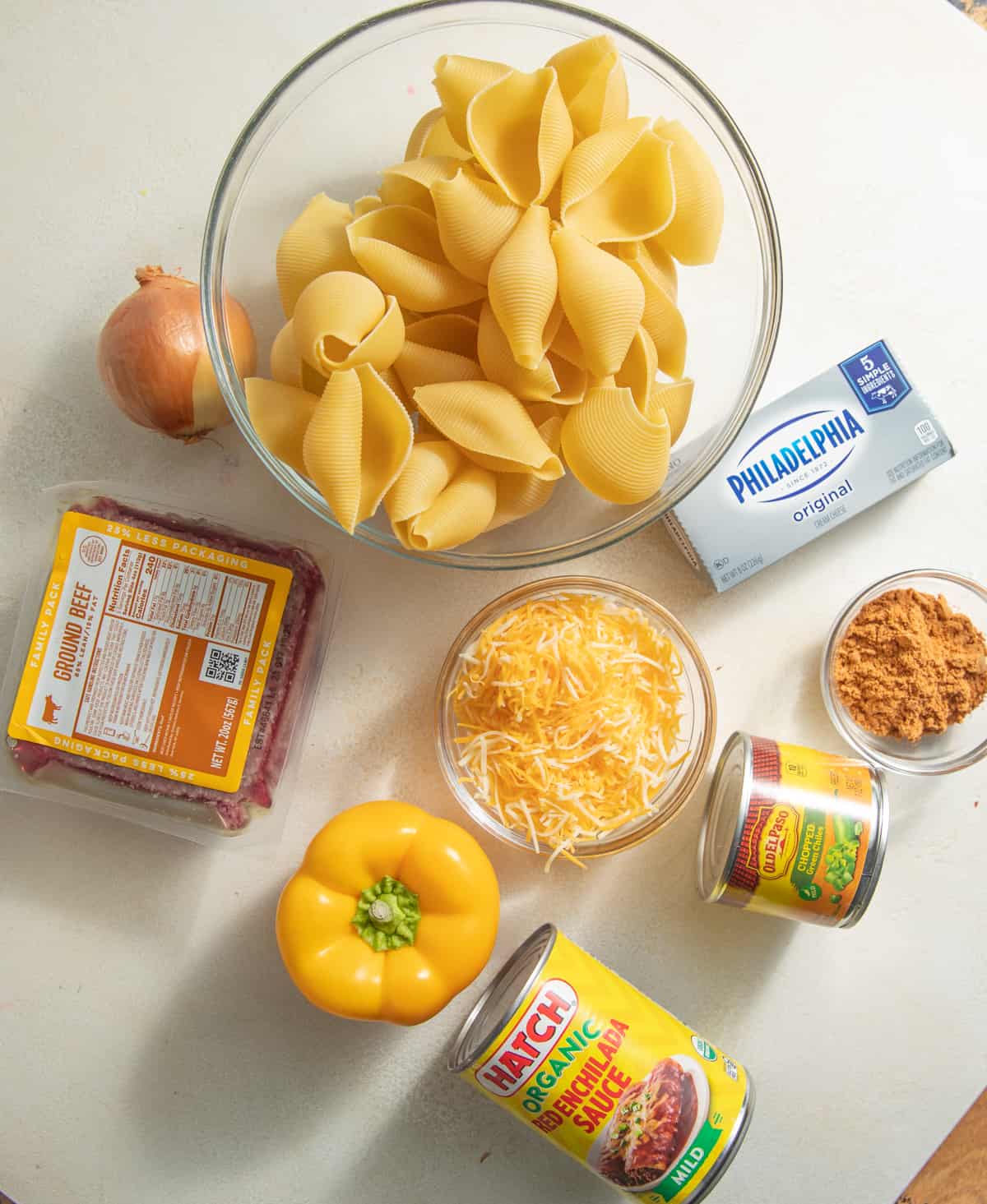 Ingredients to make Mexican stuffed shells set out on a white surface.