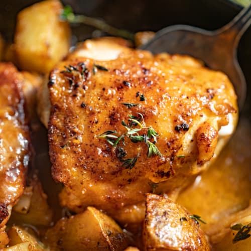 A spoon scooping up a maple dijon chicken thigh.