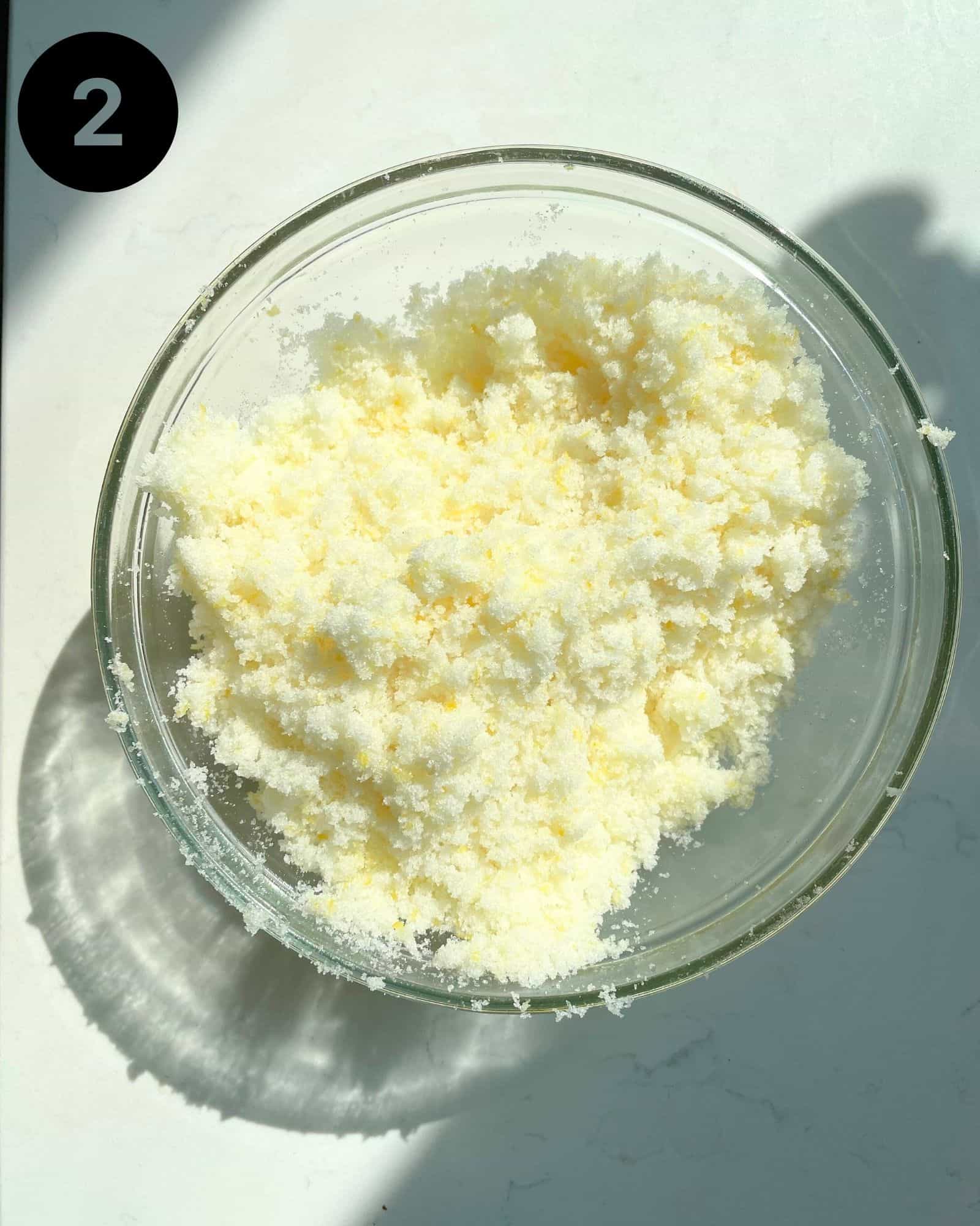 lemon zest and sugar mixed together in a mixing bowl.