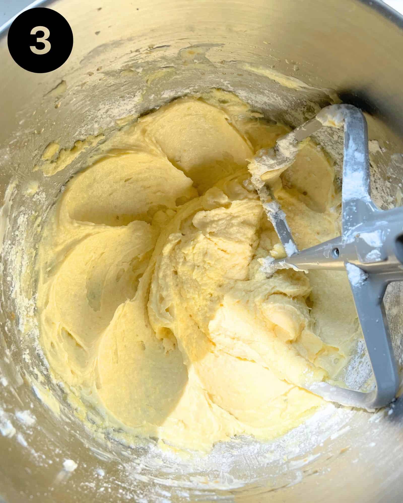cake batter in a mixing bowl with the paddle attachment.