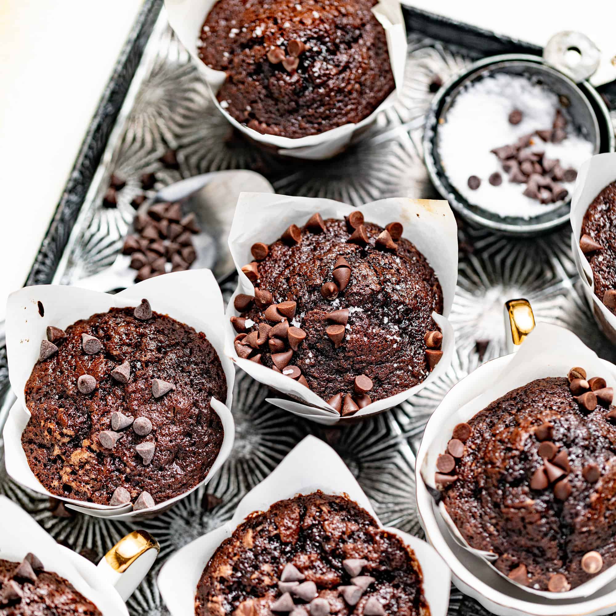 brownie muffins and chocolate chips on a silver serving tray.