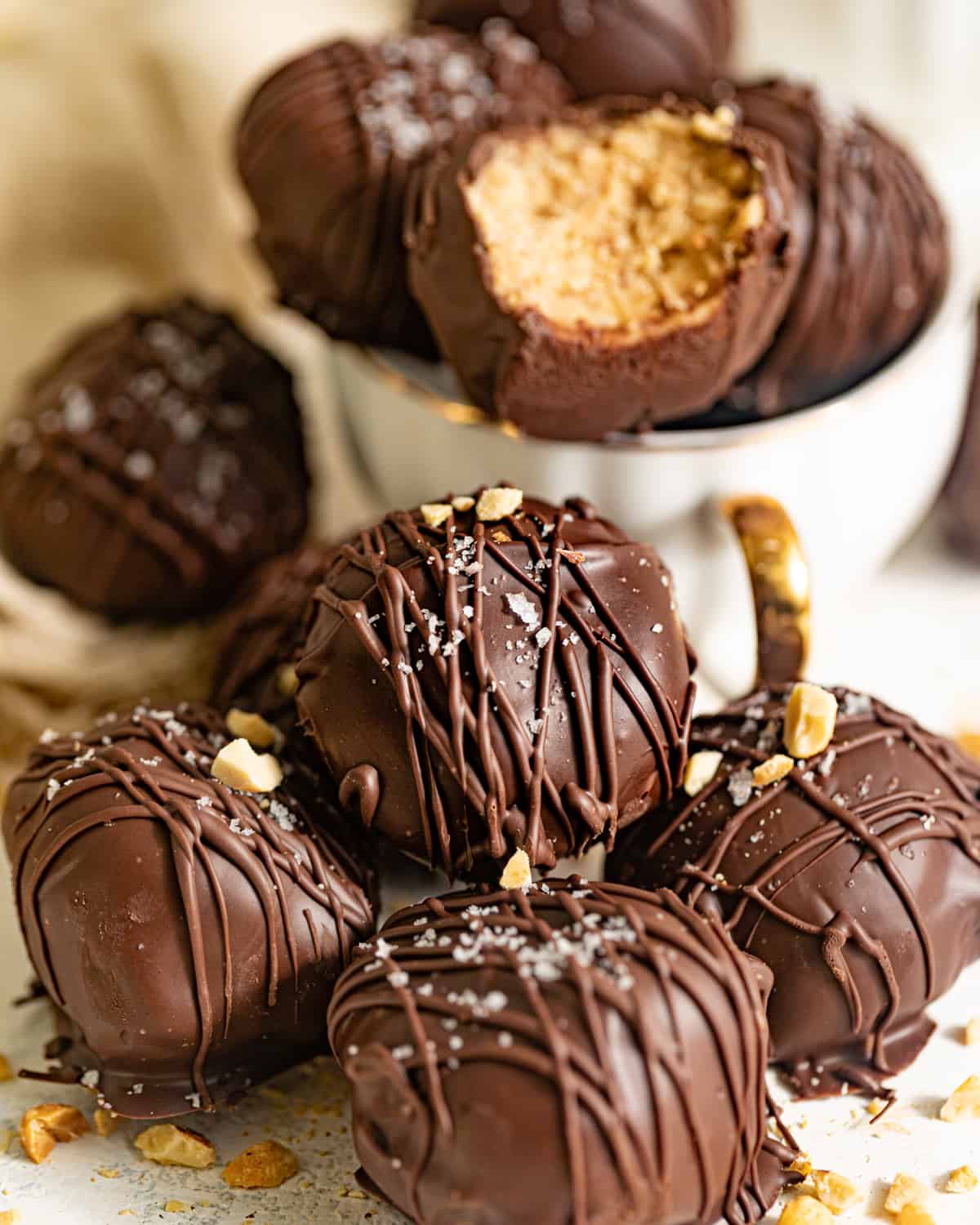 A pile of chocolate dipped peanut butter truffles.