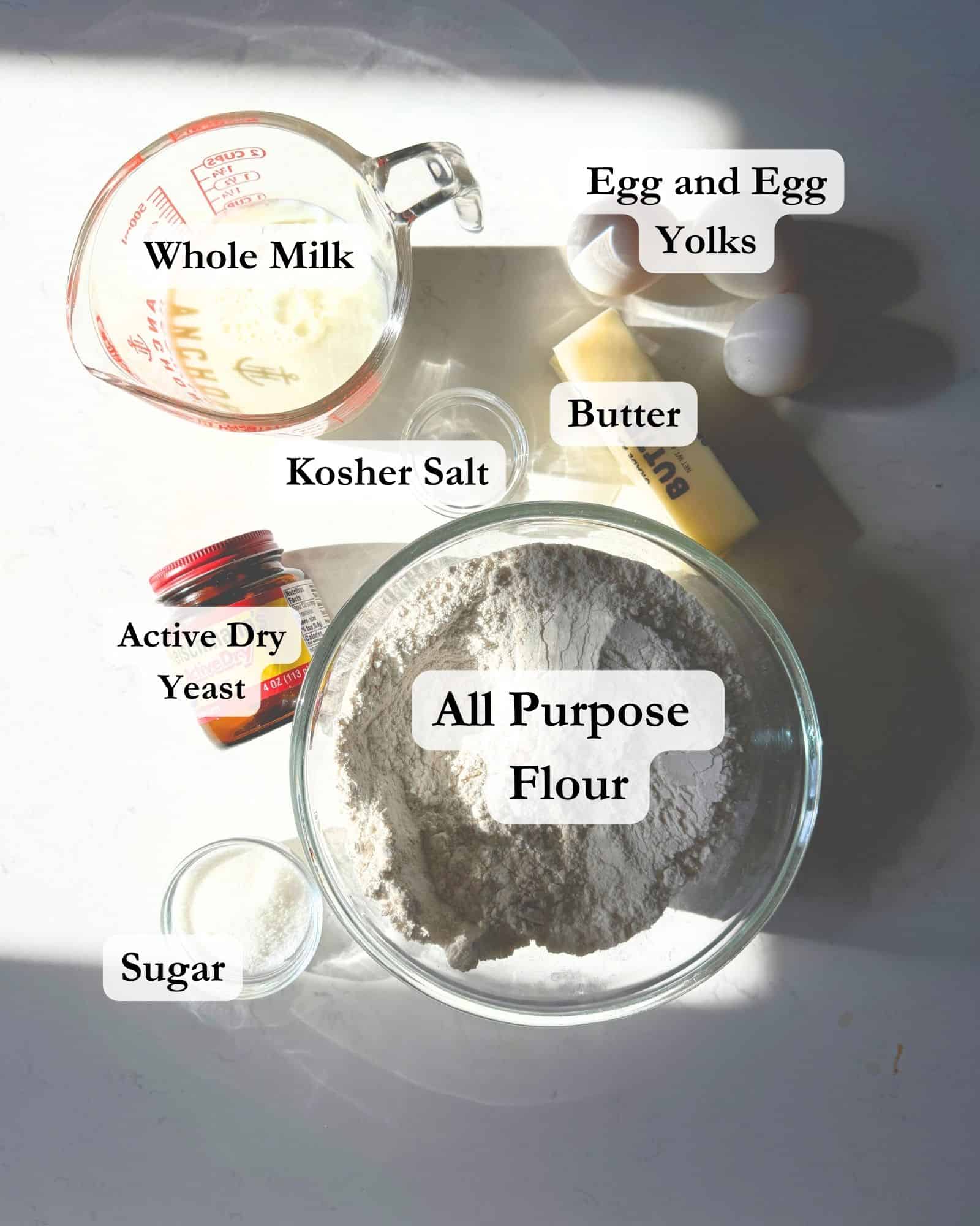 ingredients to make brown and serve dinner rolls - flour, butter, sugar, yeast, salt, eggs, and egg yolks.