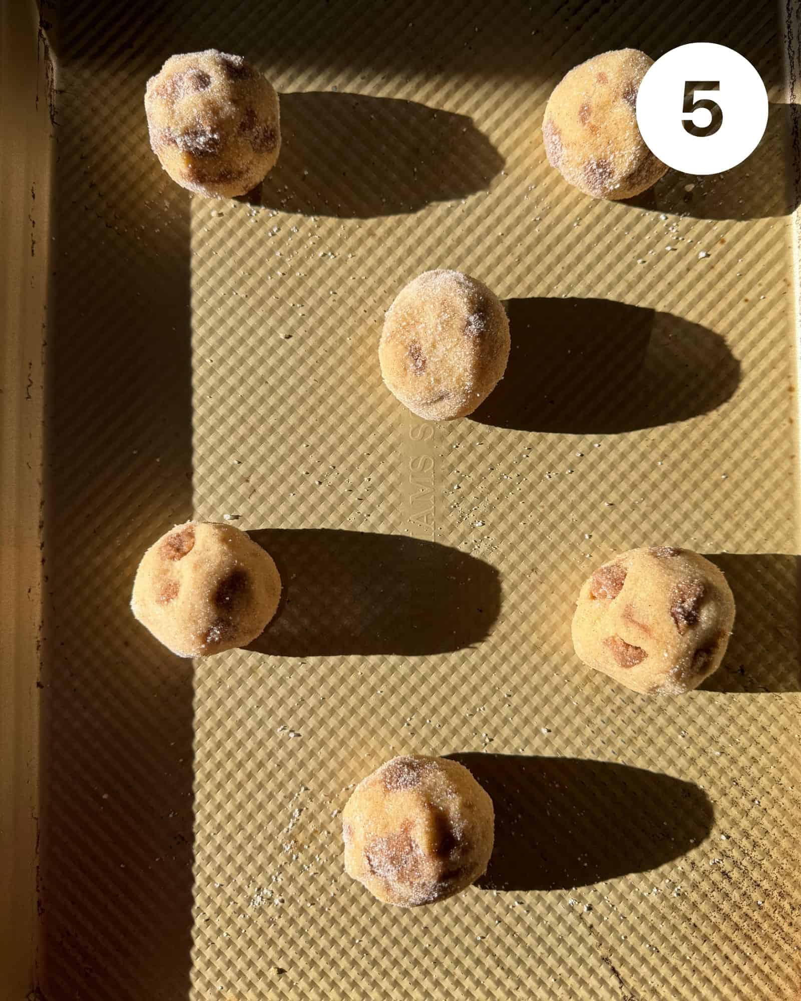 cookie dough balls on a cookie sheet