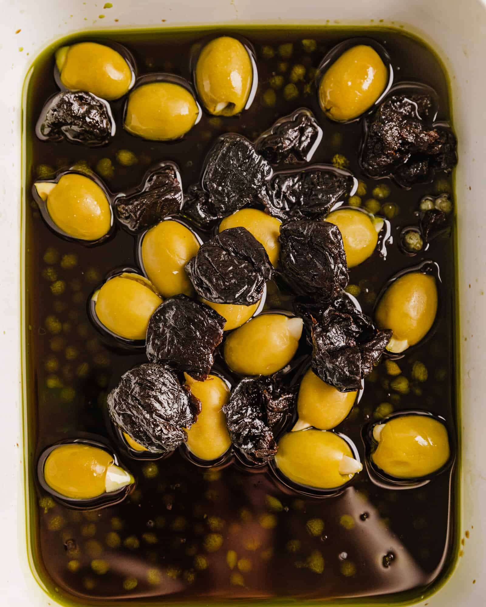 olives, prunes, balsamic vinegar, and olive oil in a bowl