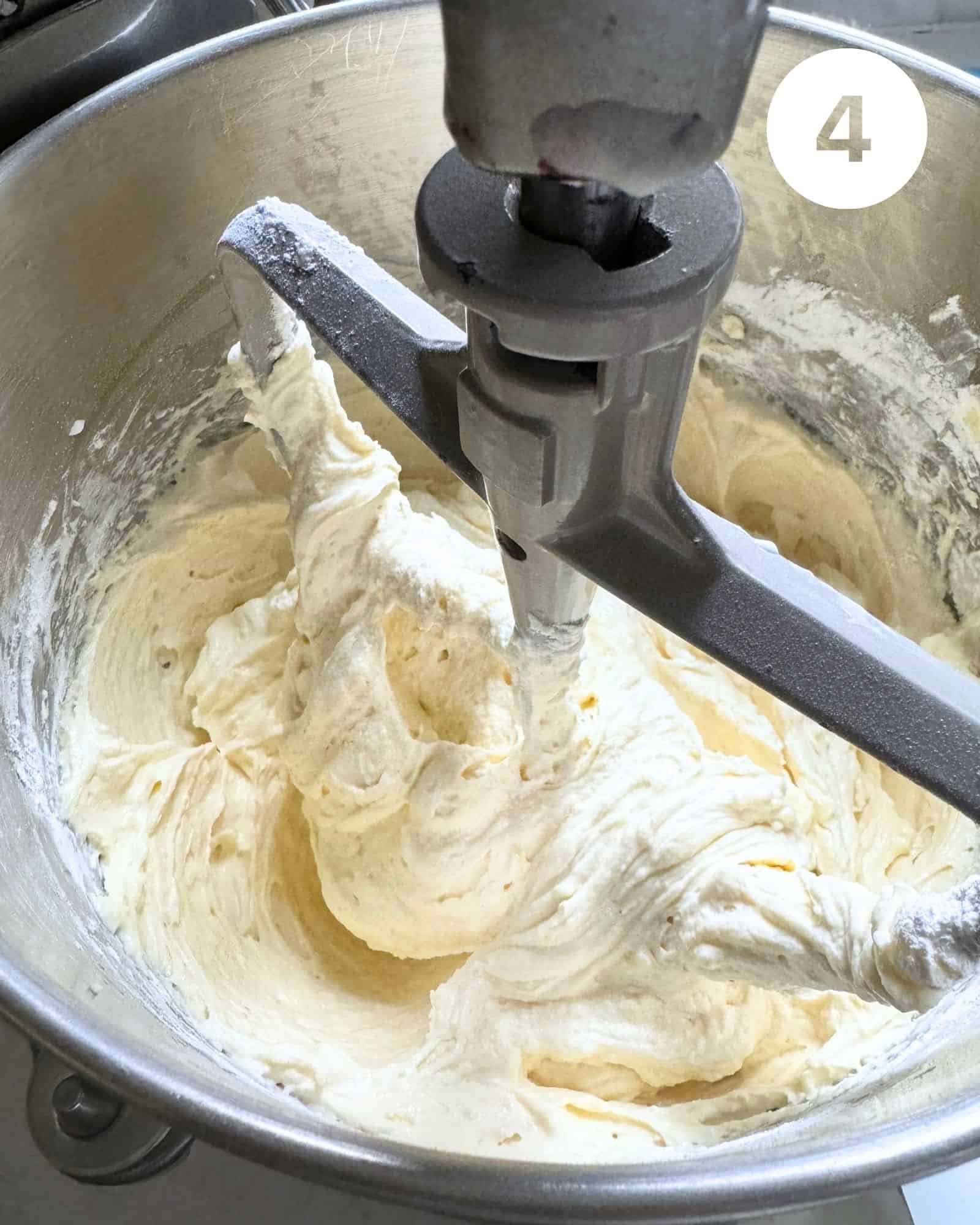 cake batter in the bowl of a stand mixer.
