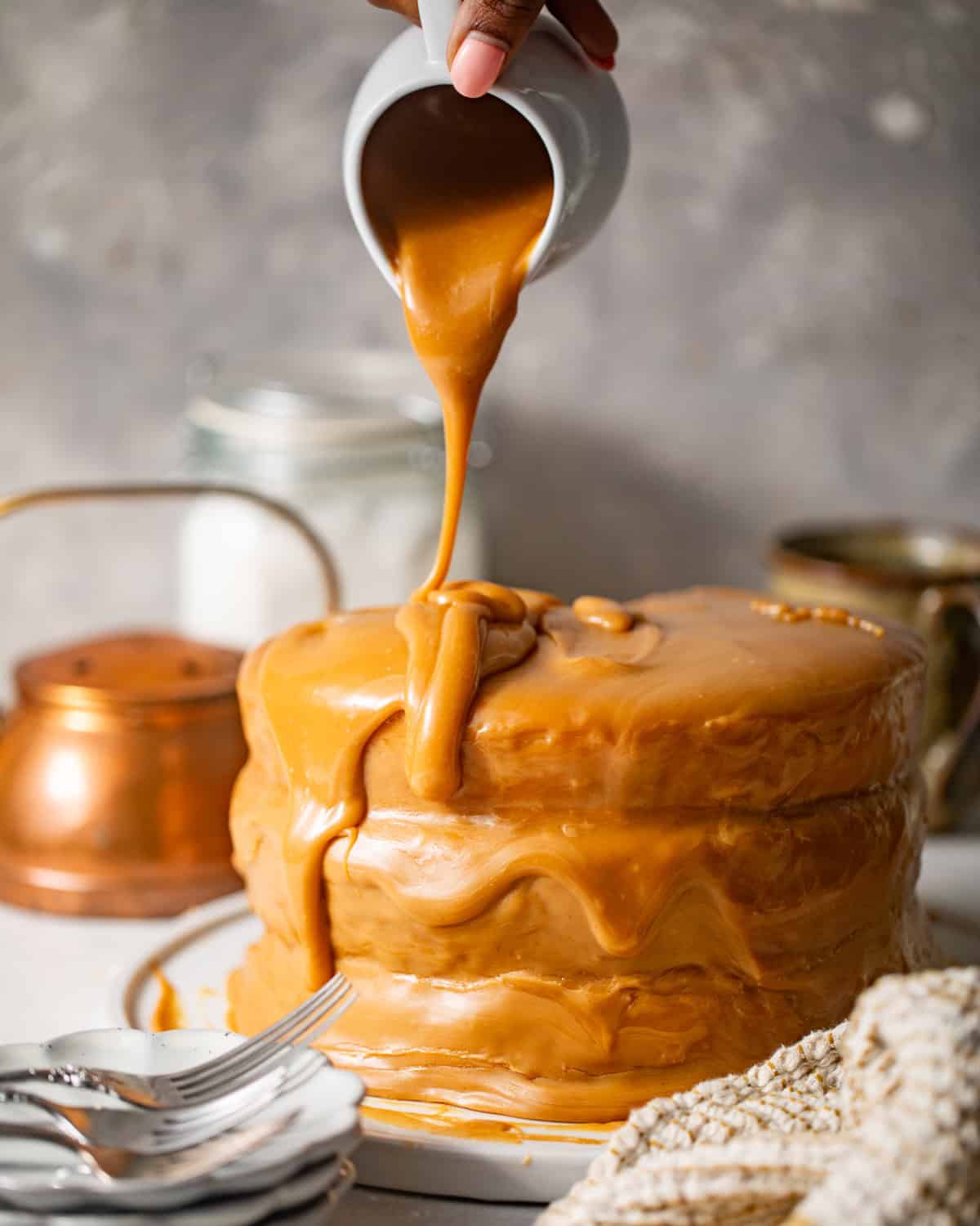 caramel icing poured onto the yellow cake.