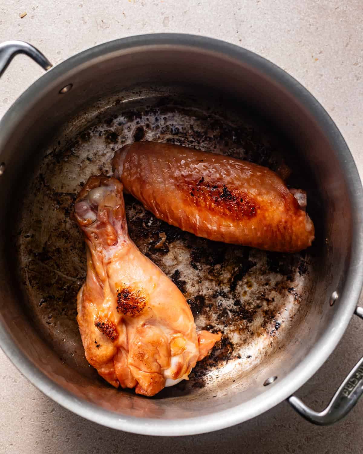 seared turkey legs in a skillet.