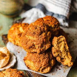sweet potato biscuits stacked on top of each other on a cutting board.