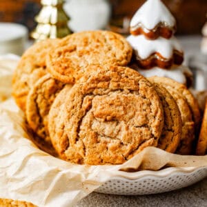 brown butter snickerdoodle cookies in a large bowl lined with parchment paper.