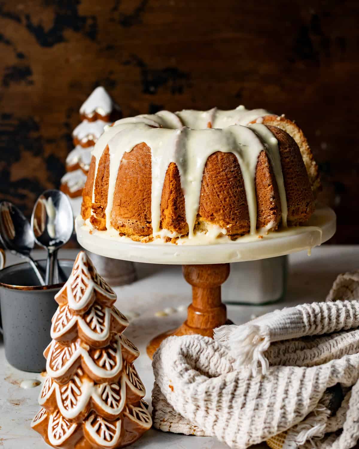 eggnog pound cake on a cake stand covered in spiced eggnog glaze and freshly grated nutmeg.