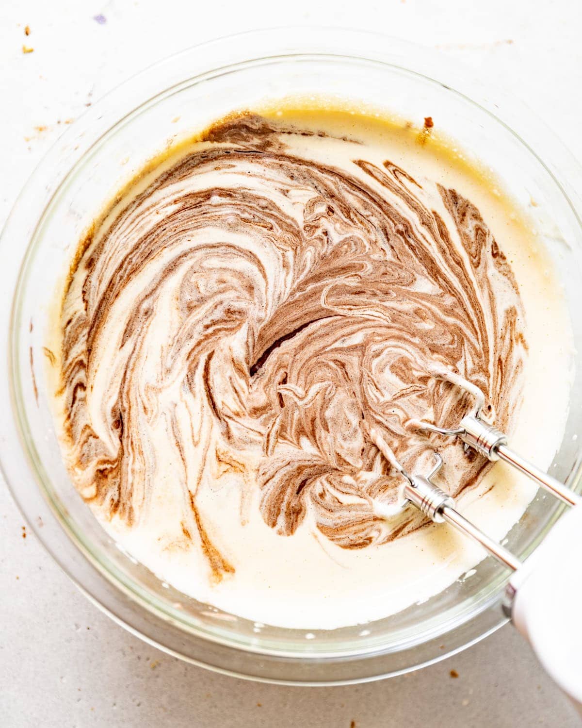 eggs and sugar whipped together in a bowl with the melted chocolate mixture added in. 