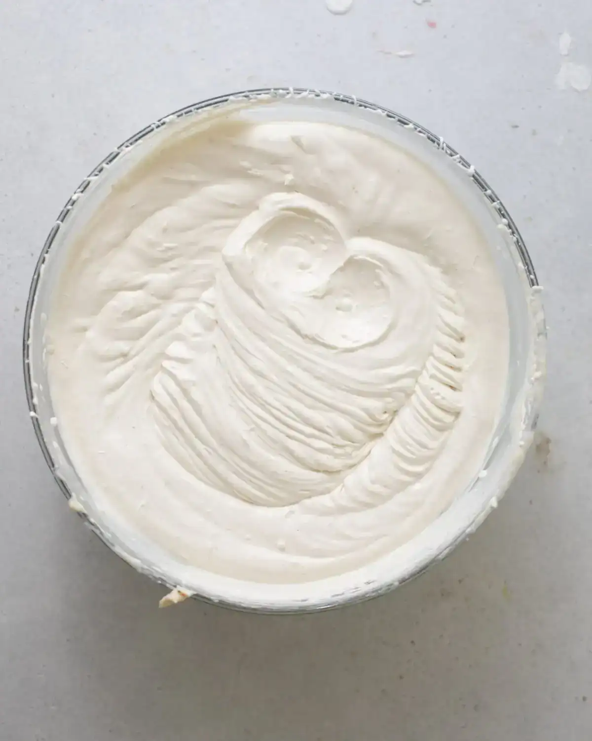 heavy cream and eggnog whipped to stiff peaks in a mixing bowl. 