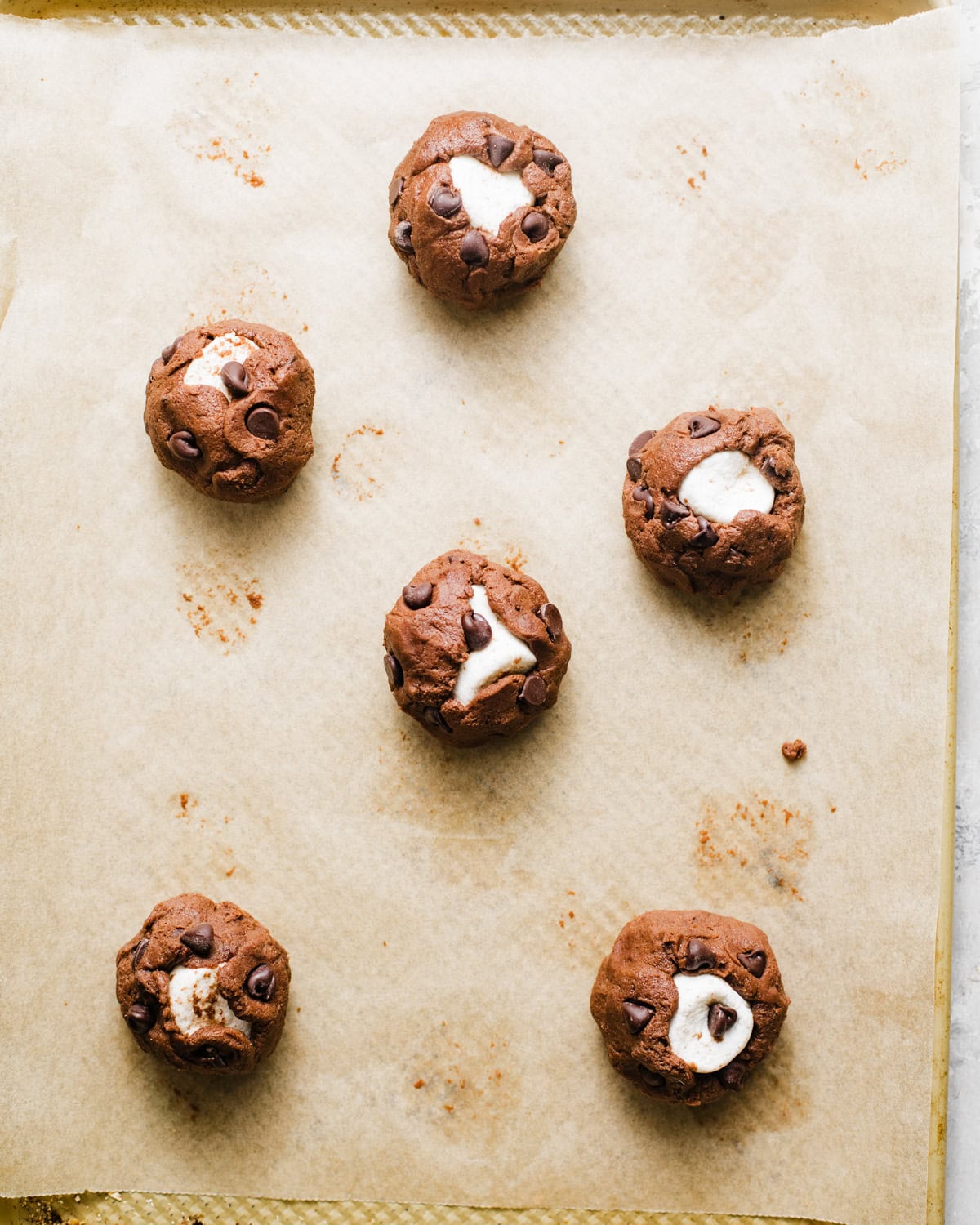 cookie dough balls on a baking sheet.