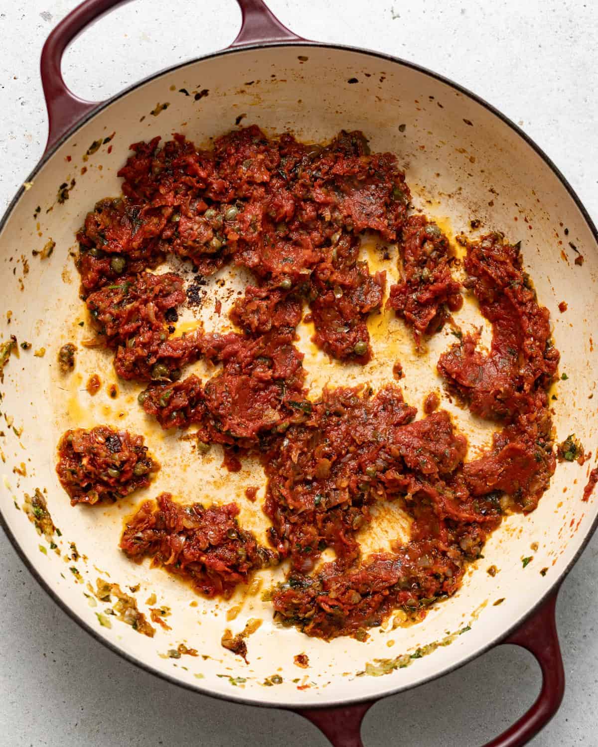shallots, garlic, seasonings, and tomato paste cooked in a skillet.