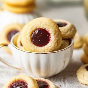 raspberry thumbprint cookies in a cup.