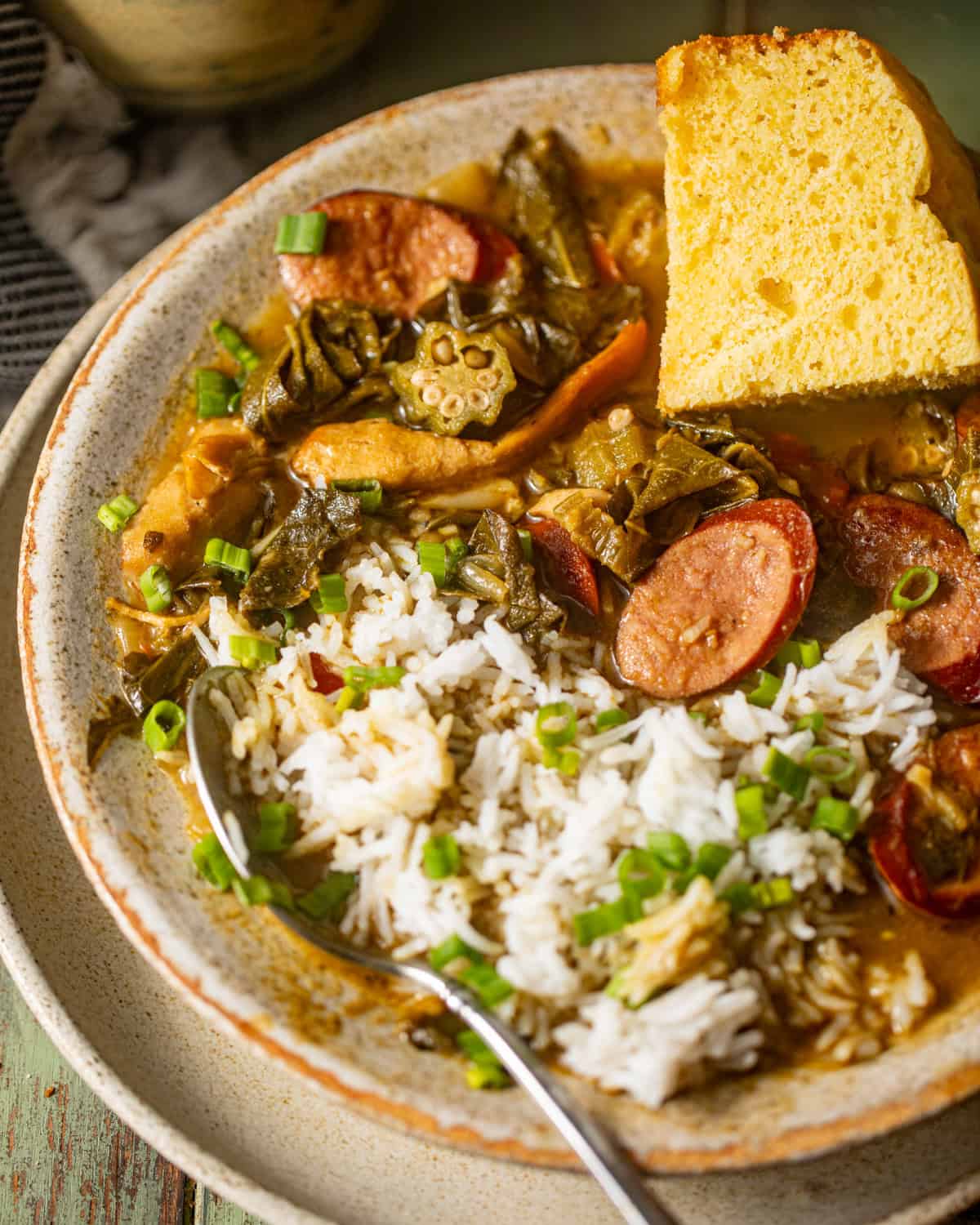 gumbo greens in a bowl with rice and cornbread.