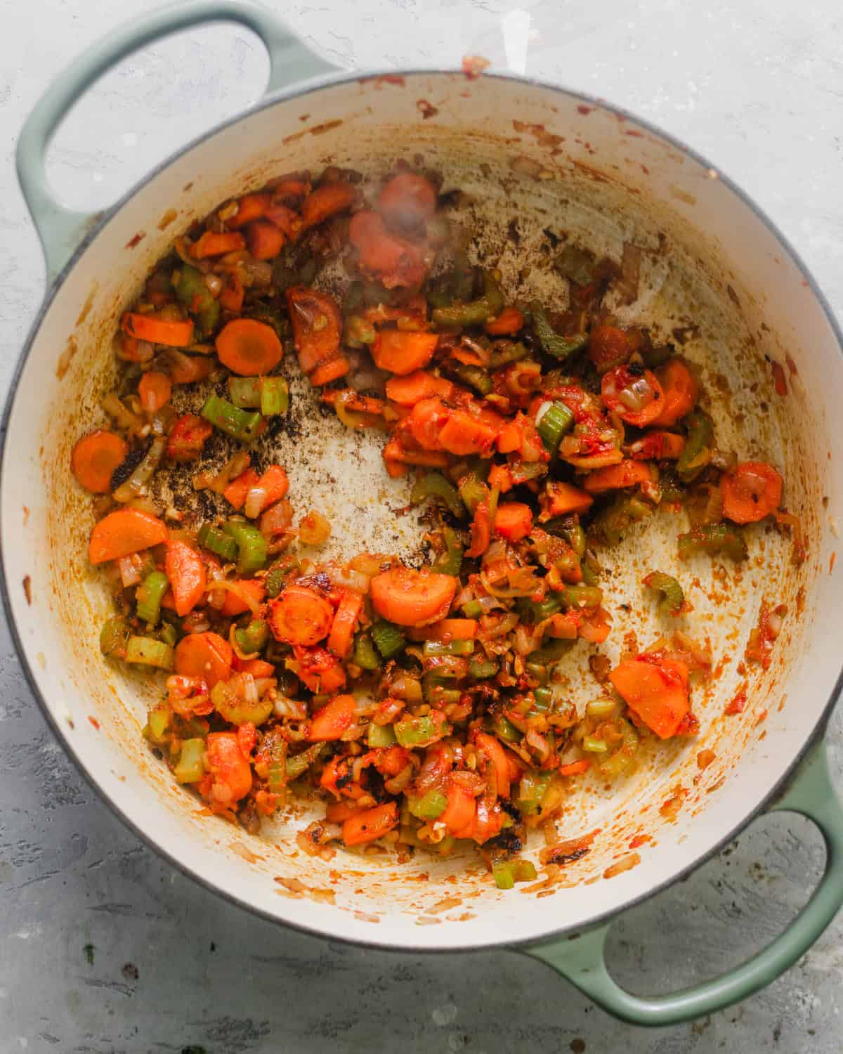 carrots, celery, garlic, shallots, tomato paste, and bouillon cooked in a pot. 