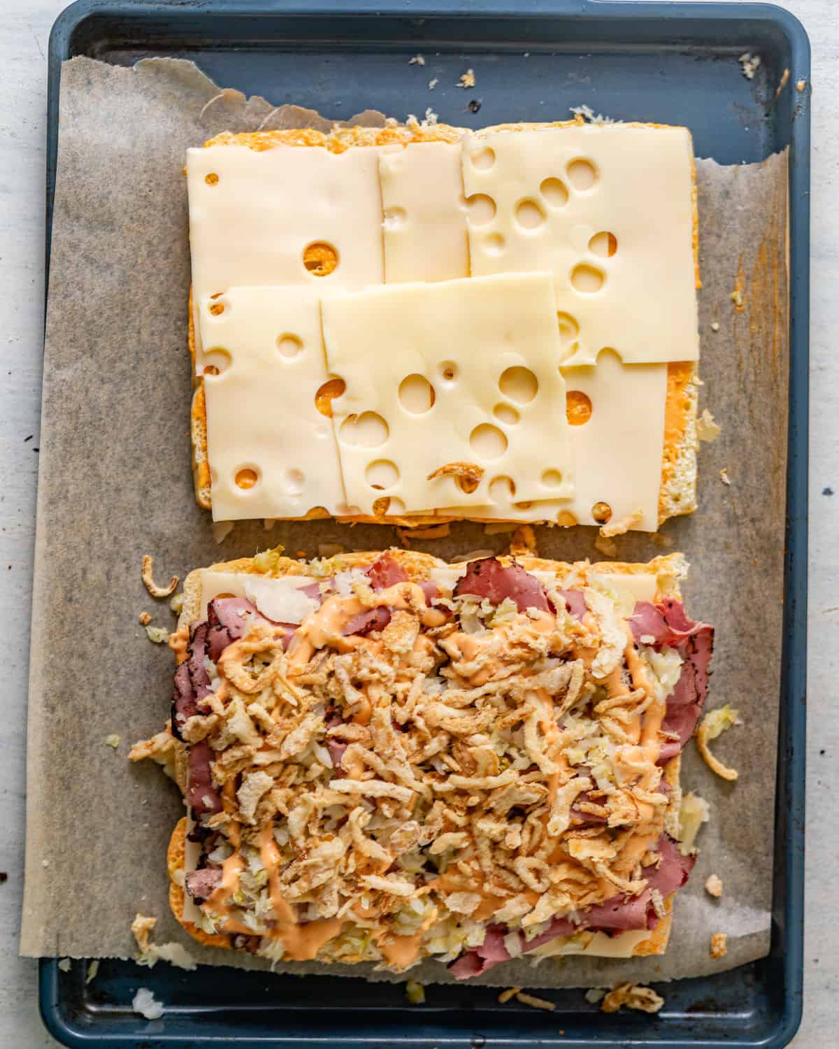 pastrami, drained sauerkraut, crispy french onions, and more thousand island dressing drizzled on top of the hawaiian rolls. 