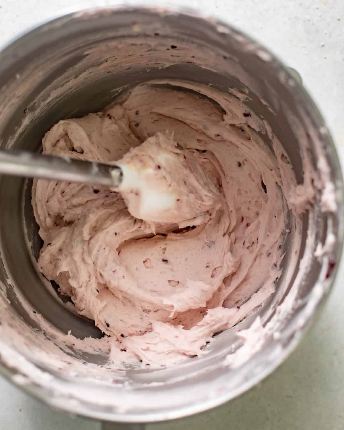 raspberry white chocolate buttercream in the bowl of a stand mixer.