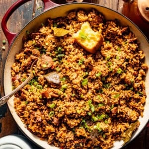 overhead photo of dirty rice in a pot with a piece of cornbread.