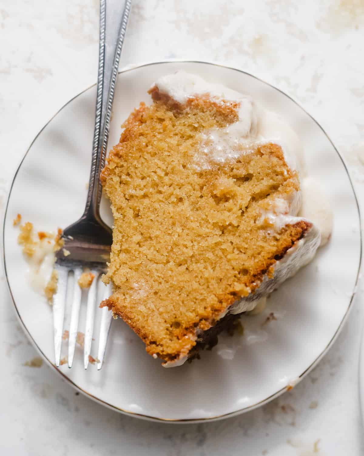 a slice of pound cake on a cake plate with a fork. 