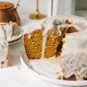burnt sugar pound cake on a plate covered with burnt sugar glaze.