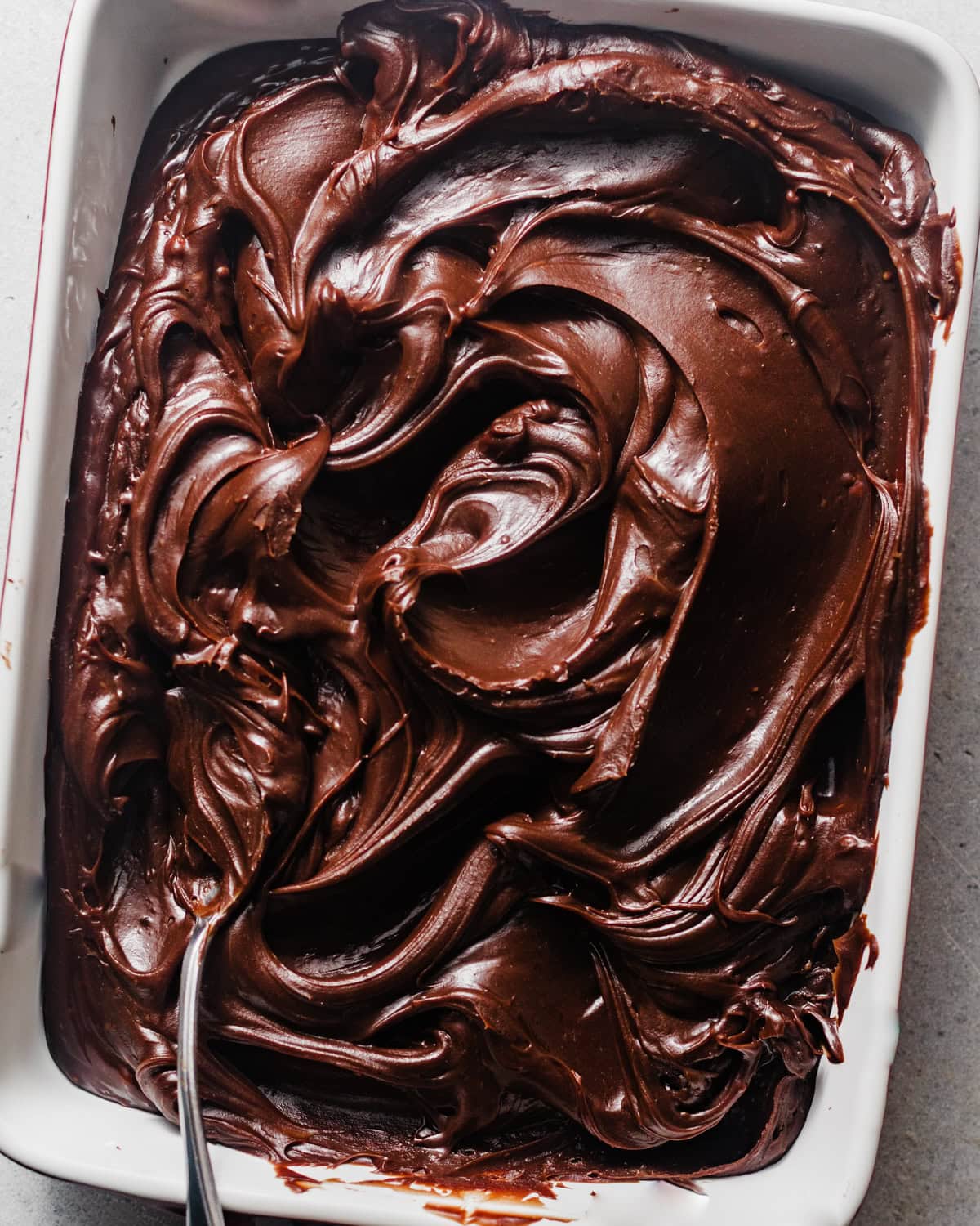 chocolate fudge frosting in a baking dish to cool. 
