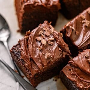 chocolate snack cake on a piece of parchment paper with spoons.