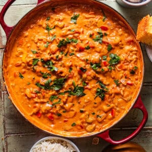 crawfish etouffee in a pot garnished with fresh parsley.