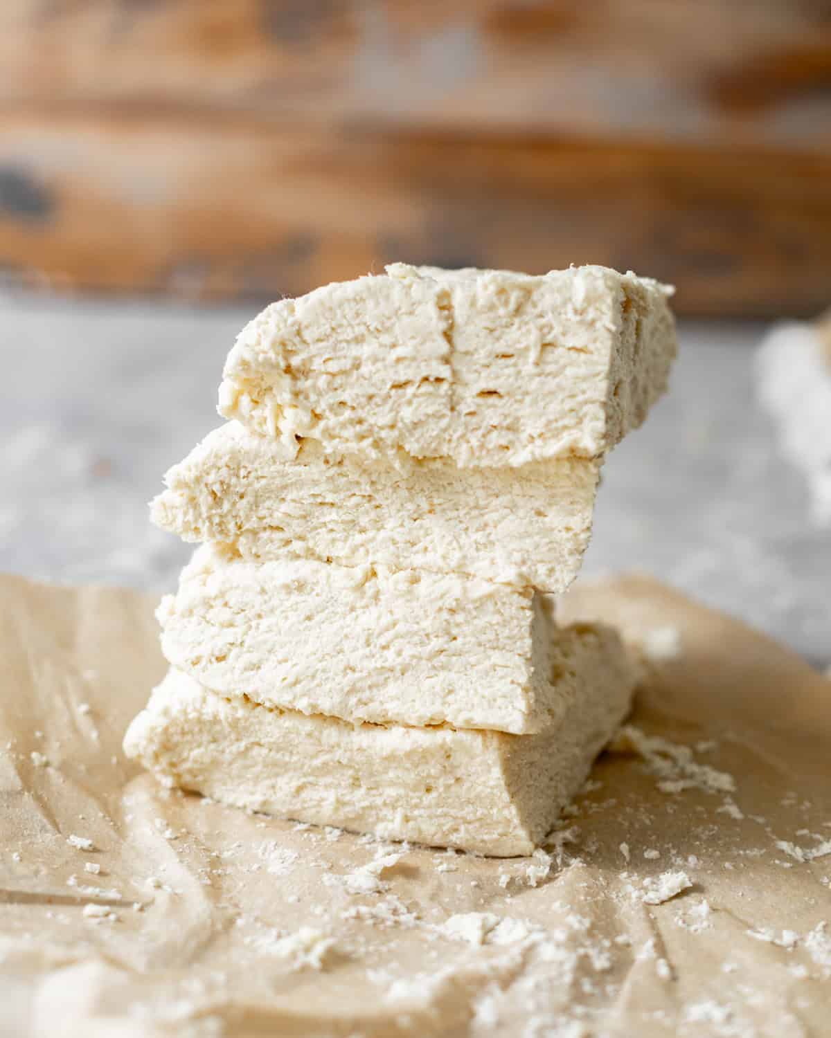 biscuit dough cut into 4 pieces and stacked on top of each other to create the flaky biscuit laters.