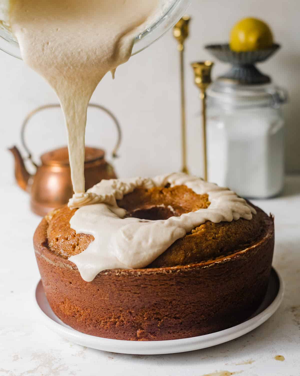 burnt sugar glaze being poured on top of the pound cake.