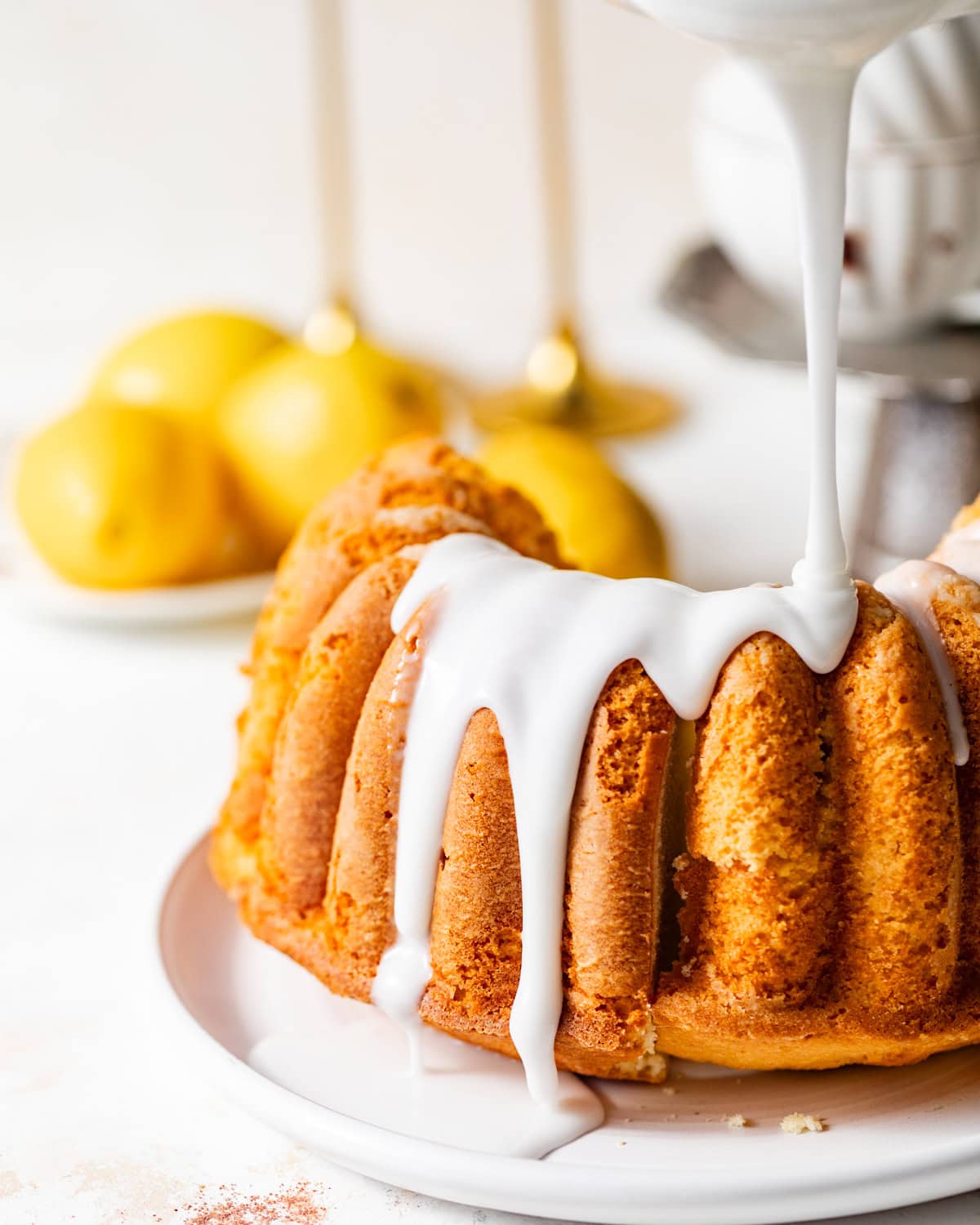 lemon glaze being poured onto the cake.