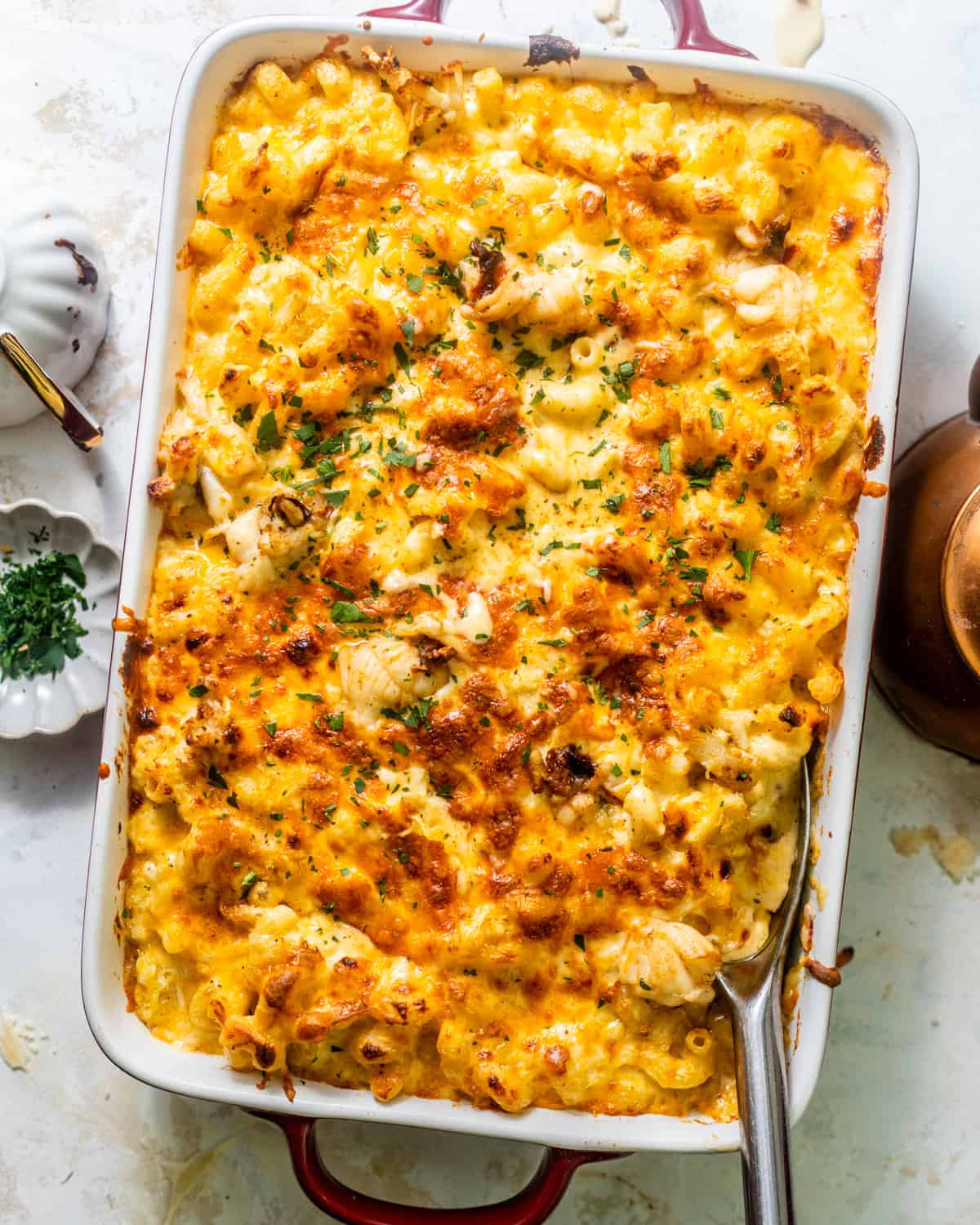 overhead photo of seafood mac and cheese in a baking dish. 