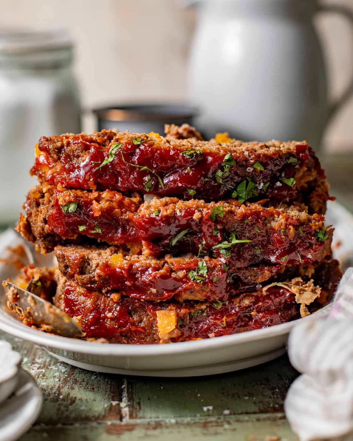sliced meatloaf stacked on top of each other. 