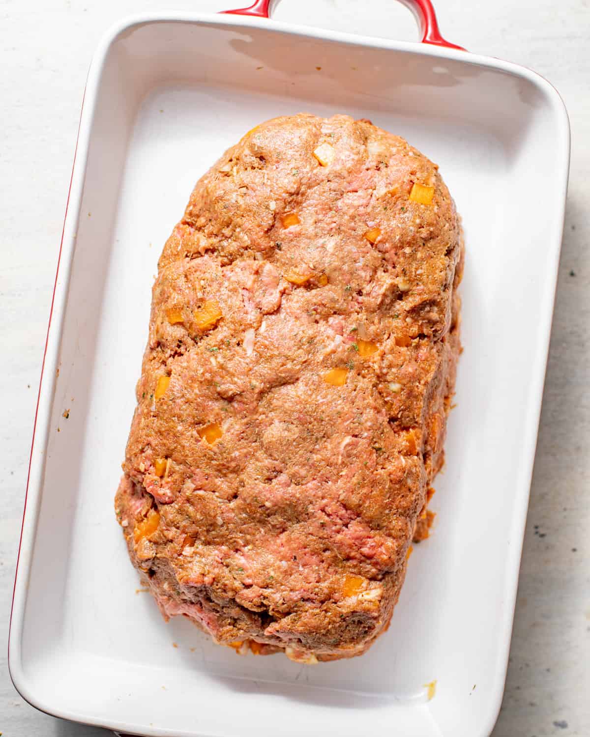 ground beef mixture shaped into a loaf in baking dish.