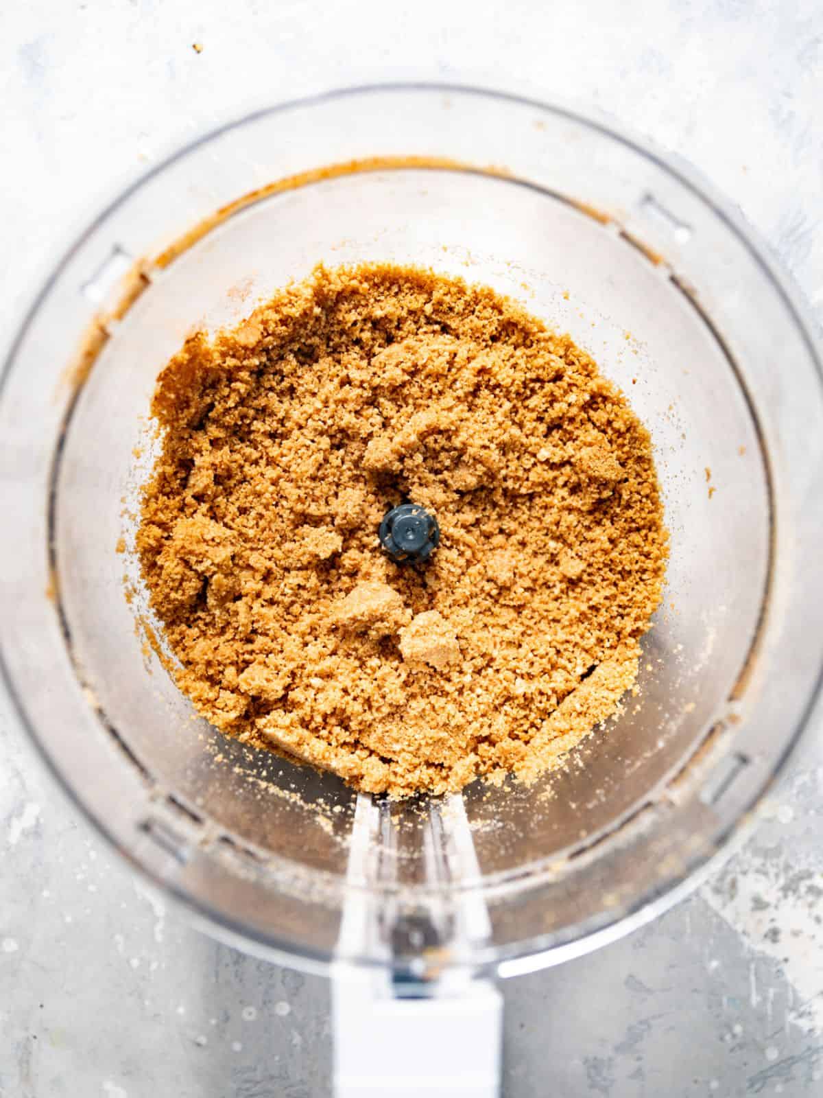graham cracker crumbs and brown blended in a food processor until fine crumbs form.
